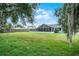 Expansive backyard with lush grass and mature trees, perfect for outdoor activities and relaxation at 229 Marcum Trace Dr, Lakeland, FL 33809