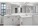 Bright bathroom features dual sinks, white cabinetry, a large mirror, and sleek finishes at 229 Marcum Trace Dr, Lakeland, FL 33809