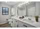 Bright bathroom with dual sinks, white cabinets, modern fixtures, and a large mirror at 229 Marcum Trace Dr, Lakeland, FL 33809