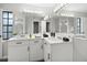 Bright bathroom features dual sinks with white cabinetry, a large mirror, and modern lighting fixtures at 229 Marcum Trace Dr, Lakeland, FL 33809
