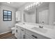 Modern bathroom featuring double sinks with quartz countertops, updated fixtures, and clean white finishes at 229 Marcum Trace Dr, Lakeland, FL 33809