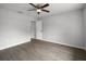 Clean, minimalist bedroom featuring a ceiling fan, updated flooring, and neutral paint at 229 Marcum Trace Dr, Lakeland, FL 33809