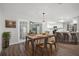 Open dining room with wood floors, a view of the kitchen, and views to other rooms at 229 Marcum Trace Dr, Lakeland, FL 33809