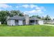 Charming home featuring stone accents, a well-manicured lawn, and a welcoming front porch at 229 Marcum Trace Dr, Lakeland, FL 33809