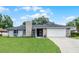 Charming single-story home with a stone facade, attached two-car garage, and well-maintained lawn at 229 Marcum Trace Dr, Lakeland, FL 33809