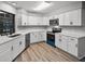 Contemporary kitchen boasts white cabinets, sleek countertops, and modern stainless steel appliances at 229 Marcum Trace Dr, Lakeland, FL 33809