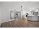 Spacious living room with hardwood floors, featuring a view into the modern, open kitchen area at 229 Marcum Trace Dr, Lakeland, FL 33809