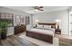 Serene main bedroom features a dark wood furnishings, neutral decor, and ample natural light at 229 Marcum Trace Dr, Lakeland, FL 33809
