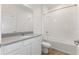 White bathroom featuring a vanity with a gray countertop and a shower-over-tub combination at 2292 Sirena Ln, Mount Dora, FL 32757