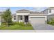 Charming single-story home featuring a two-car garage, well-manicured lawn, and inviting front entrance at 2292 Sirena Ln, Mount Dora, FL 32757