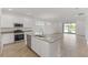Bright, modern kitchen with stainless steel appliances, central island, and white cabinetry at 2292 Sirena Ln, Mount Dora, FL 32757