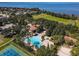 Aerial view highlighting the community pool, clubhouse, and lush landscaping, near a lake at 2313 Pesaro Cir, Ocoee, FL 34761