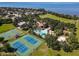 Aerial view of community amenities featuring tennis and basketball courts, a pool, and a clubhouse near the water at 2313 Pesaro Cir, Ocoee, FL 34761