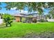 A lush backyard leads to a screened pool, merging indoor comfort with nature's tranquility at 2313 Pesaro Cir, Ocoee, FL 34761