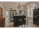 Home bar with seating, cabinets, and arched window with plantation shutters at 2313 Pesaro Cir, Ocoee, FL 34761