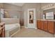 Bathroom featuring a soaking tub, walk-in shower with glass door, and ample counter space at 2313 Pesaro Cir, Ocoee, FL 34761