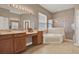 Bathroom with tiled floors, a soaking tub, a glass enclosed shower, and a large vanity at 2313 Pesaro Cir, Ocoee, FL 34761