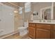 Bathroom featuring a glass enclosed shower, a sink with wooden cabinets, and a toilet at 2313 Pesaro Cir, Ocoee, FL 34761