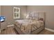 Bedroom showcasing neutral tones, a comfortable bed, and hardwood floors, providing a relaxing ambiance at 2313 Pesaro Cir, Ocoee, FL 34761