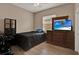 Bedroom featuring a comfortable bed, wooden floors, and a large wooden dresser with flat screen television at 2313 Pesaro Cir, Ocoee, FL 34761
