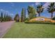 Entrance to the community featuring lush landscaping, a sign, and a brick-paved street at 2313 Pesaro Cir, Ocoee, FL 34761