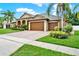 Charming single-story house with a brick driveway, lush landscaping, and a convenient three-car garage at 2313 Pesaro Cir, Ocoee, FL 34761
