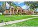 Inviting single-story home with well-maintained lawn, mature landscaping, and a convenient three-car garage at 2313 Pesaro Cir, Ocoee, FL 34761