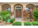 Inviting front entrance showcasing a double door entry surrounded by lush landscaping at 2313 Pesaro Cir, Ocoee, FL 34761