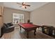 Cozy game room with a pool table, ceiling fan, and window at 2313 Pesaro Cir, Ocoee, FL 34761