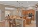 Open kitchen features custom cabinets, granite countertops, an island, and a breakfast bar with pendant lighting at 2313 Pesaro Cir, Ocoee, FL 34761