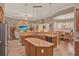 Spacious open kitchen with a large island, granite countertops, a breakfast bar, and stainless steel appliances at 2313 Pesaro Cir, Ocoee, FL 34761