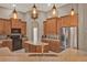 A spacious kitchen featuring custom cabinets, stainless appliances, and a large island with granite countertops at 2313 Pesaro Cir, Ocoee, FL 34761