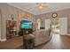 Comfortable living room featuring wood floors, a ceiling fan, and a sliding door to the outdoor space at 2313 Pesaro Cir, Ocoee, FL 34761