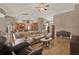 Spacious living room featuring wood floors and an open floor plan to the kitchen and dining area at 2313 Pesaro Cir, Ocoee, FL 34761