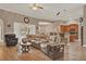 Cozy living room featuring wood floors, ceiling fan and open floor plan to dining area and kitchen at 2313 Pesaro Cir, Ocoee, FL 34761