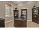 A cozy home office featuring custom cabinets, a built-in desk, and a large window with natural light at 2313 Pesaro Cir, Ocoee, FL 34761
