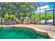 A serene pool area is screened-in, complemented by lounge seating and lush plants at 2313 Pesaro Cir, Ocoee, FL 34761
