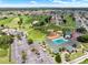 An aerial shot captures the community amenities, including a pool, golf course, and tennis courts, nestled within a residential area at 2520 Nw 53Rd Avenue Rd, Ocala, FL 34482