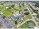 An aerial view showcases the community pool, tennis courts, and golf course surrounded by well-maintained homes and lush landscaping at 2520 Nw 53Rd Avenue Rd, Ocala, FL 34482