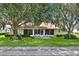 Charming home featuring a cozy screened-in patio and a lush green lawn at 2520 Nw 53Rd Avenue Rd, Ocala, FL 34482