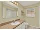 This bathroom features a white sink, vanity, mirror, and shower and toilet for a clean aesthetic at 2520 Nw 53Rd Avenue Rd, Ocala, FL 34482
