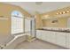 Bright bathroom featuring a large tub, glass shower, dual sinks, and a vanity at 2520 Nw 53Rd Avenue Rd, Ocala, FL 34482