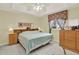 Comfortable bedroom with light blue bedding, wood furniture, and a neutral wall color at 2520 Nw 53Rd Avenue Rd, Ocala, FL 34482