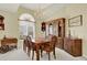 Elegant dining room with a large window, chandelier, and classic wooden furniture for formal dining at 2520 Nw 53Rd Avenue Rd, Ocala, FL 34482