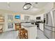 Modern kitchen with stainless steel appliances, island seating, and easy access to the outdoor patio at 2520 Nw 53Rd Avenue Rd, Ocala, FL 34482