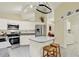 Well-equipped kitchen with modern appliances, white cabinets, and convenient access to the laundry room at 2520 Nw 53Rd Avenue Rd, Ocala, FL 34482