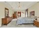 Bright bedroom featuring a tray ceiling, neutral walls, and classic wooden furniture at 2520 Nw 53Rd Avenue Rd, Ocala, FL 34482