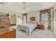 Spacious main bedroom with a tray ceiling, ceiling fan, and decorative floral curtains at 2520 Nw 53Rd Avenue Rd, Ocala, FL 34482
