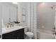 Well-lit bathroom featuring a shower-tub combo with modern tile, dark vanity, and framed art at 2757 Redblush Ter, St Cloud, FL 34772