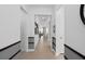 Bright hallway features stylish wainscoting, tiled floors, and leads to sun-filled living area at 2757 Redblush Ter, St Cloud, FL 34772